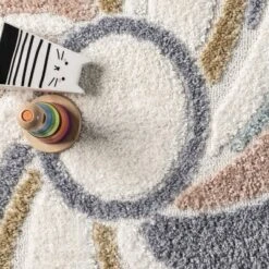 Theodora Colorful Swirl Kids Tassel Area Rug -Roommates Store GUEST fcf6084c b223 49a0 95d2 c926dd45af18